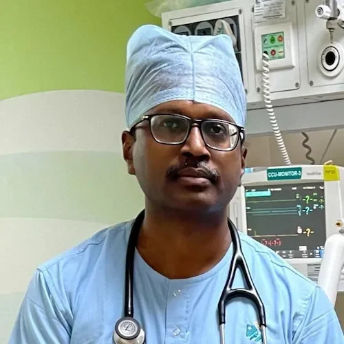 a man wearing a blue scrubs and a stethoscope around his neck