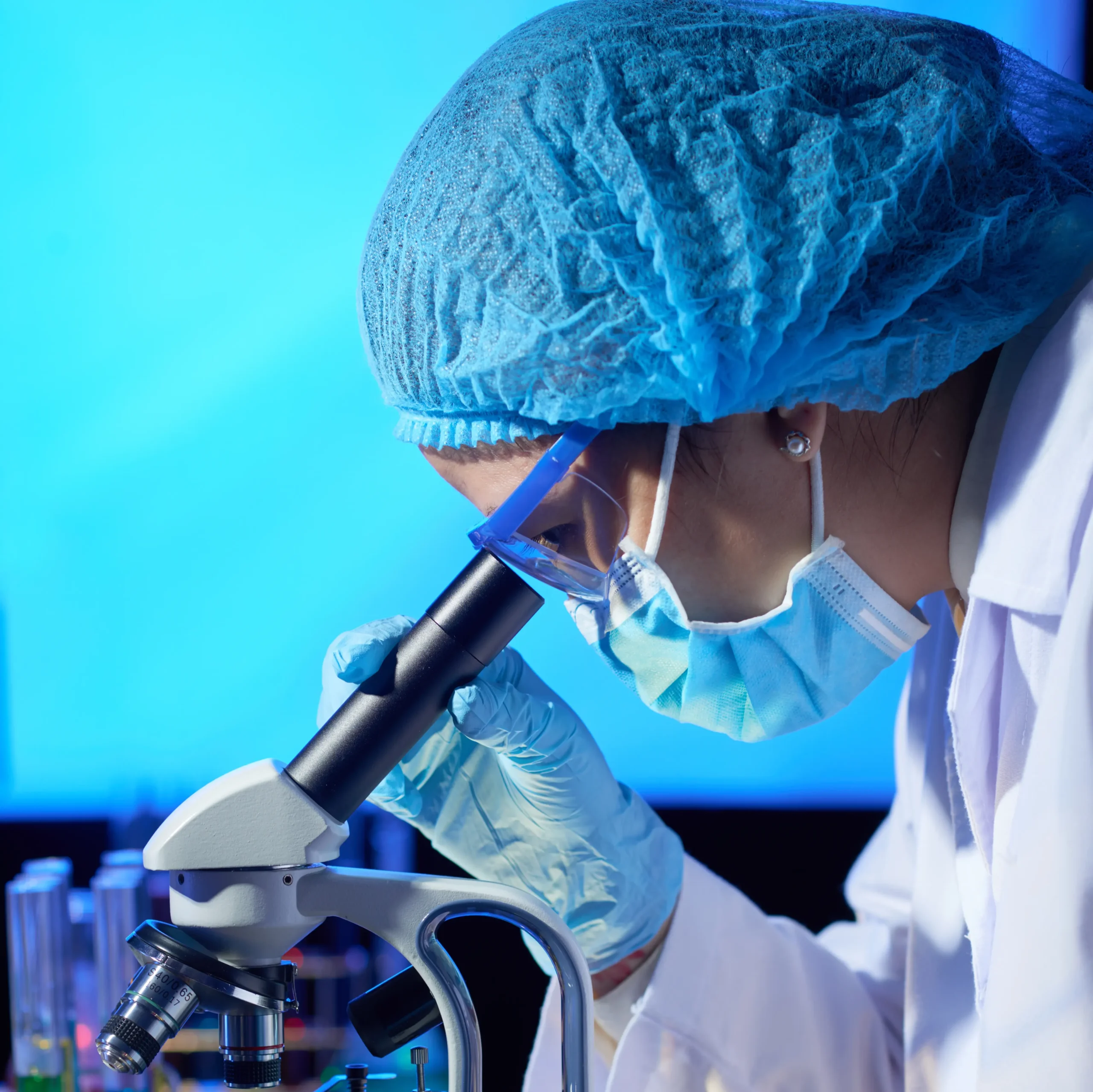 laboratory-worker-looking-through-microscope